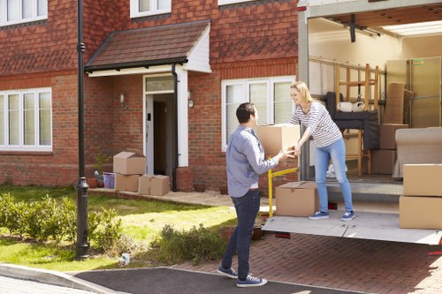 Removal van and moving team in Kingston Vale residential street