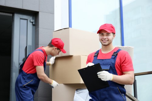 Moving team loading furniture with safety gear in Kingstonvale