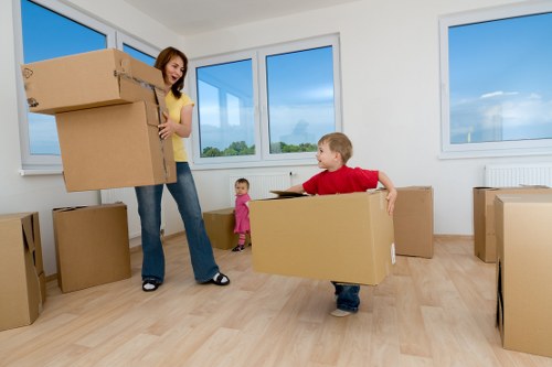 Professional movers loading household items into a van
