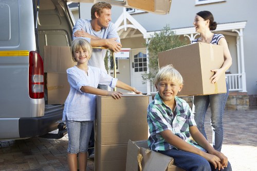 Packed moving boxes and furniture prepared for transport in Kingston Vale