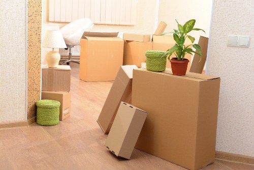 Packed boxes and furniture ready for a home move in Kingston Vale