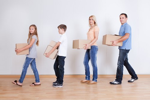 Professional movers handling office furniture for a Kingston Vale business move